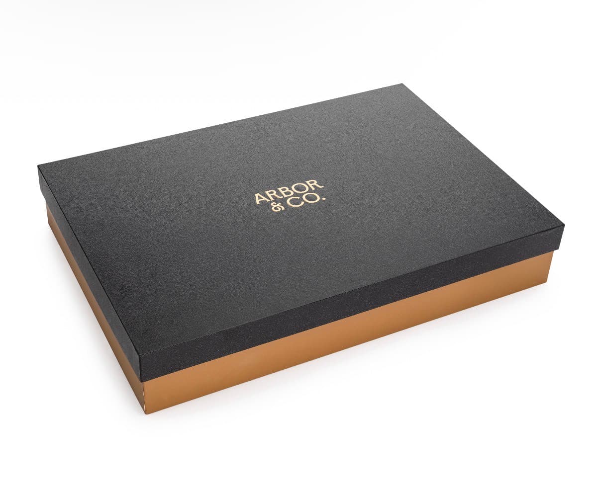 Arbor & Co. presentation box: textured charcoal lid, gold wordmark, warm brown base